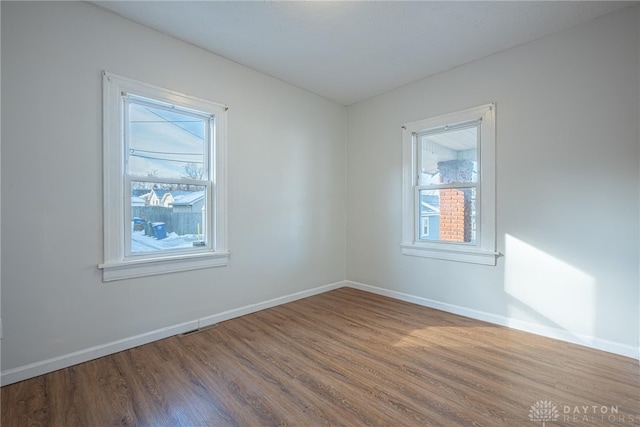 spare room with hardwood / wood-style floors