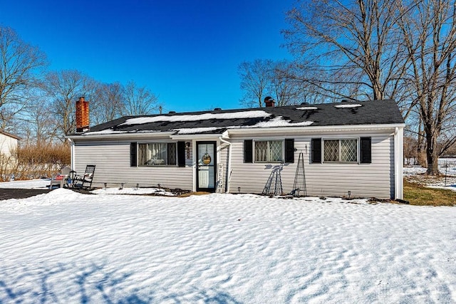 view of snow covered rear of property