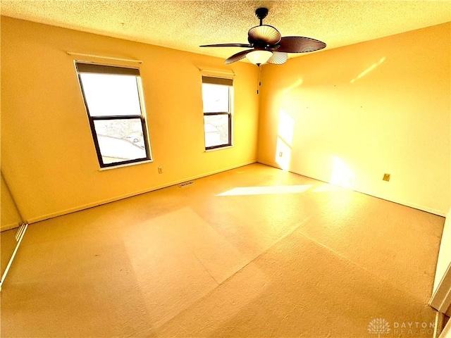 spare room featuring ceiling fan and a textured ceiling