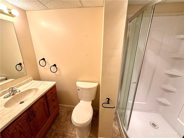 bathroom featuring vanity, tile patterned floors, a shower with door, and toilet