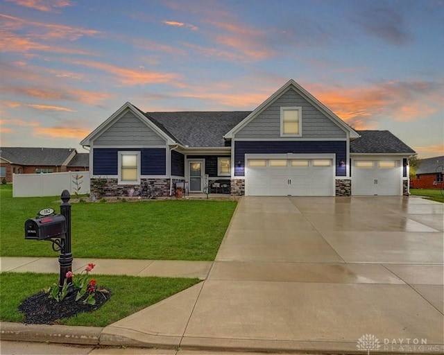 craftsman house with a garage and a lawn