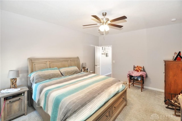 bedroom featuring light colored carpet and ceiling fan