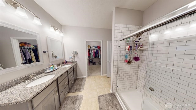 bathroom with vanity, tile patterned flooring, a shower with shower door, and a textured ceiling