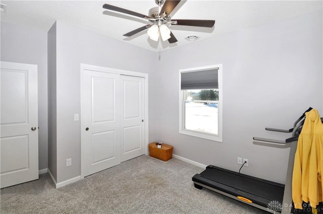 workout room featuring light colored carpet and ceiling fan