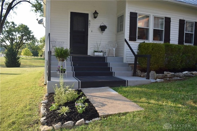 doorway to property featuring a yard