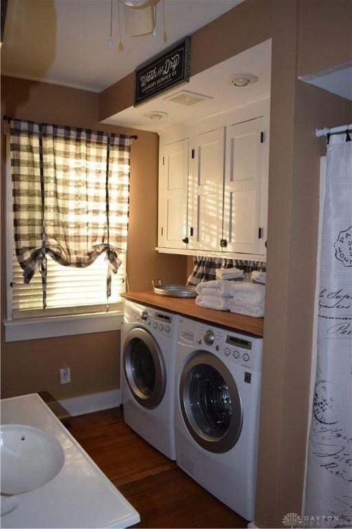 washroom featuring independent washer and dryer and dark hardwood / wood-style floors