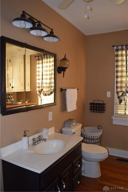 bathroom with hardwood / wood-style flooring, vanity, toilet, and plenty of natural light