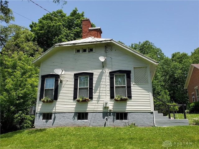 view of property exterior featuring a lawn