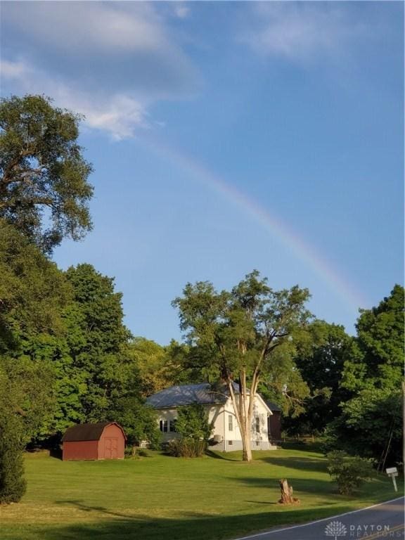 2282 Whitey Marshall Dr, Beavercreek, OH 45434 - view of grassy yard featuring a storage shed and a wooded view