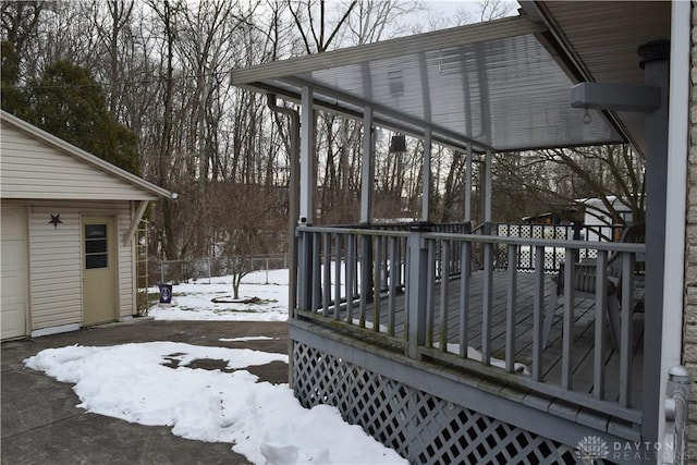 snow covered deck with an outdoor structure