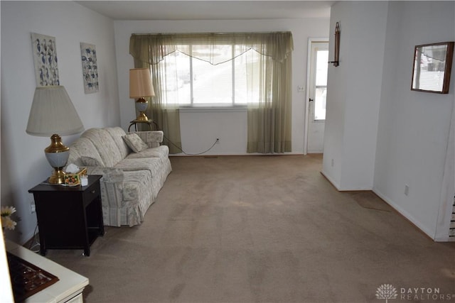 carpeted living room featuring plenty of natural light