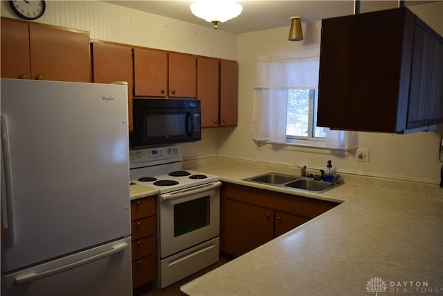 kitchen featuring sink and white appliances