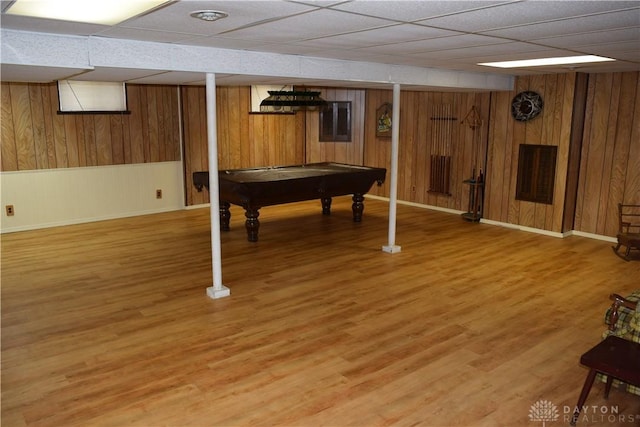 rec room featuring a paneled ceiling, wood-type flooring, billiards, and wood walls