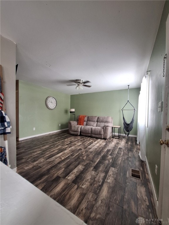 unfurnished living room with ceiling fan and dark hardwood / wood-style flooring