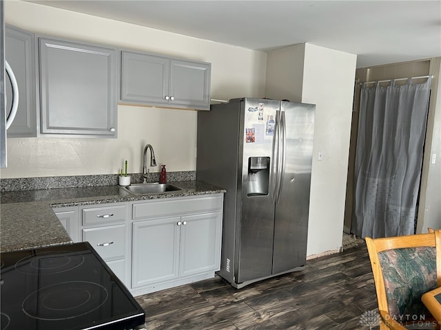 kitchen with dark hardwood / wood-style flooring, sink, electric range, and stainless steel fridge