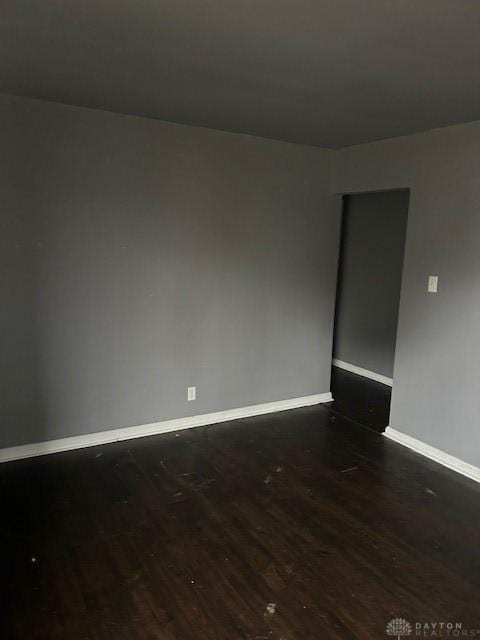 spare room featuring dark hardwood / wood-style flooring