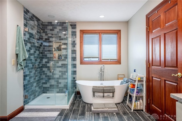 bathroom featuring vanity and independent shower and bath