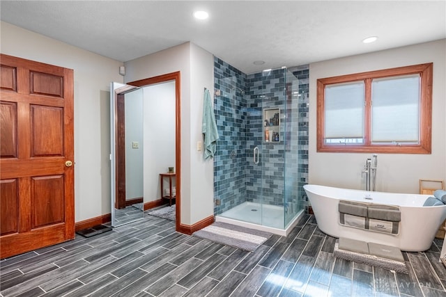 bathroom featuring shower with separate bathtub