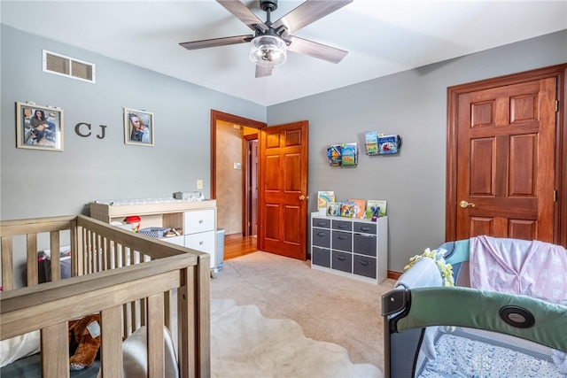 bedroom featuring light colored carpet and ceiling fan