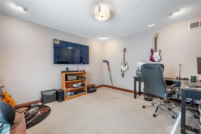 office with carpet and a textured ceiling