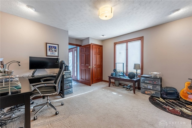 carpeted home office with a textured ceiling