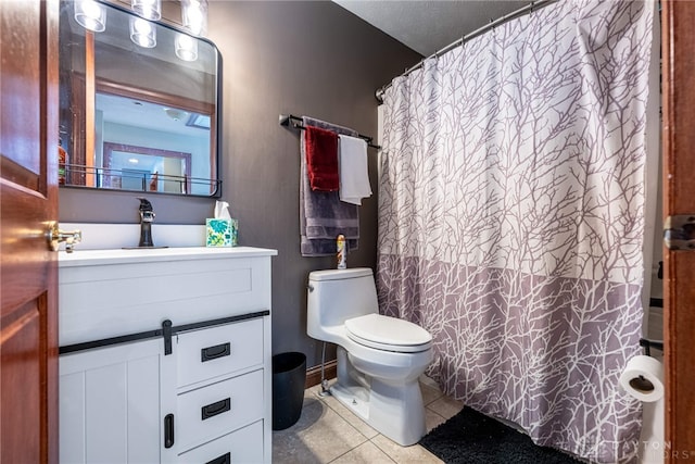 bathroom with a shower with curtain, tile patterned floors, toilet, and vanity