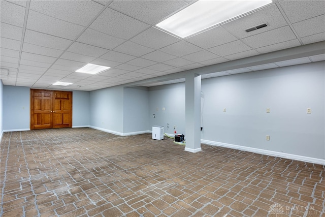 basement featuring a paneled ceiling