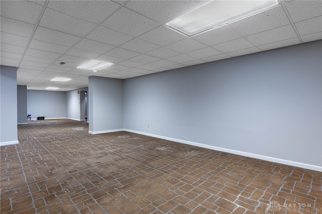 basement featuring a drop ceiling