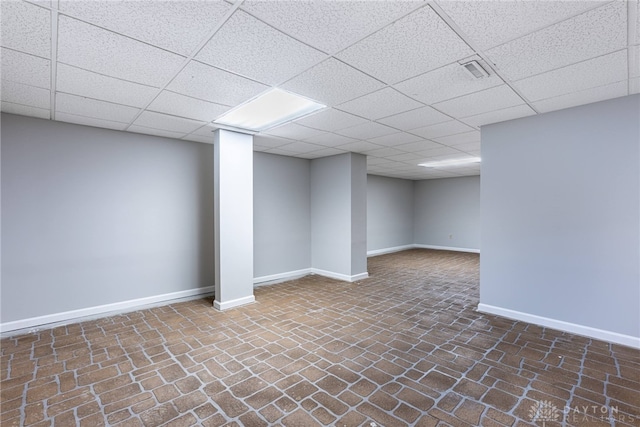 basement featuring a paneled ceiling