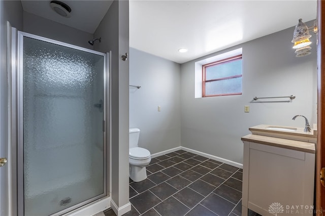 bathroom with a shower with door, vanity, and toilet