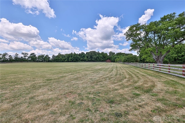 view of yard with a rural view and fence