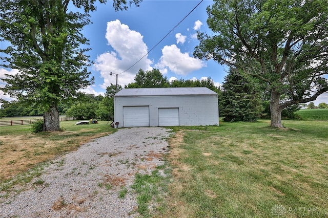 detached garage featuring fence