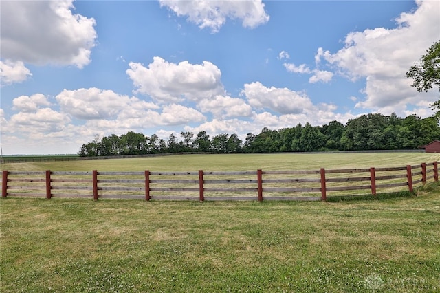 view of yard with a rural view and fence