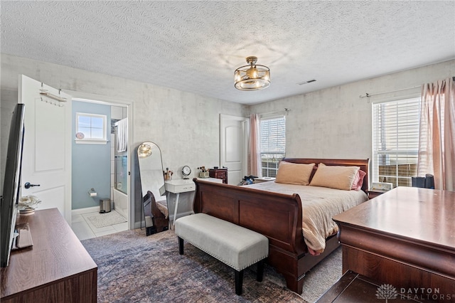 bedroom with multiple windows, visible vents, and a textured ceiling