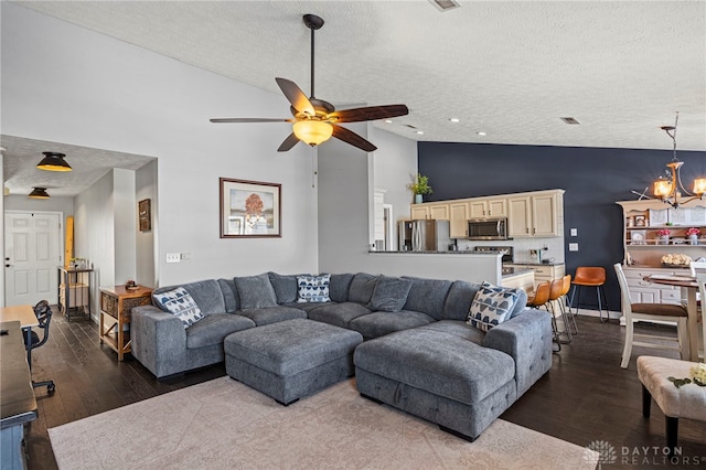 living area featuring a textured ceiling, high vaulted ceiling, wood finished floors, and ceiling fan with notable chandelier