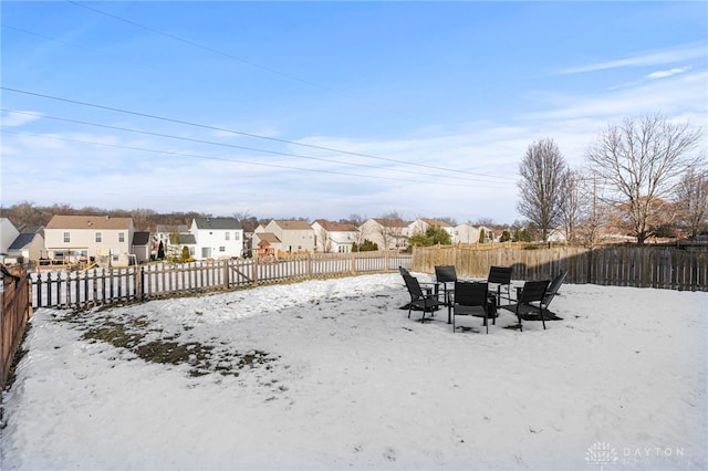 snowy yard with a fenced backyard and a residential view