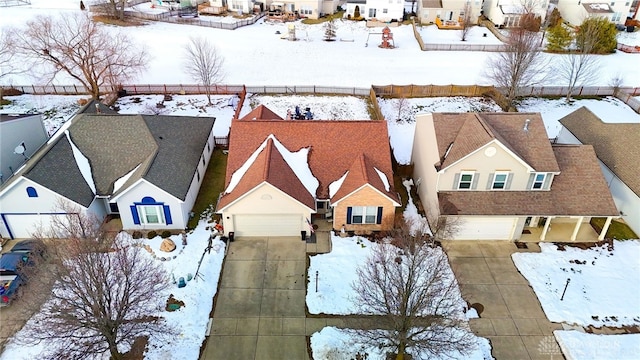 snowy aerial view with a residential view