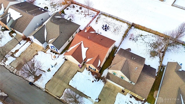 snowy aerial view featuring a residential view