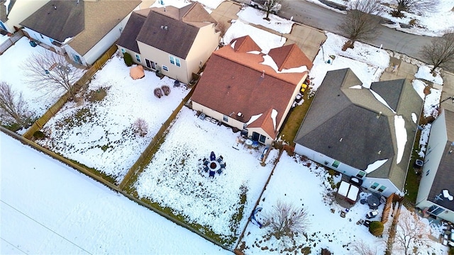 snowy aerial view with a residential view