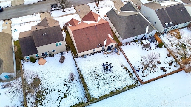 snowy aerial view with a residential view