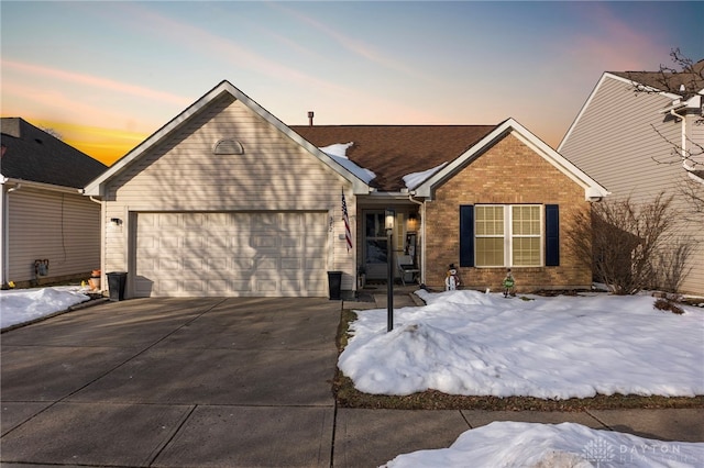 ranch-style house with a garage, brick siding, and driveway