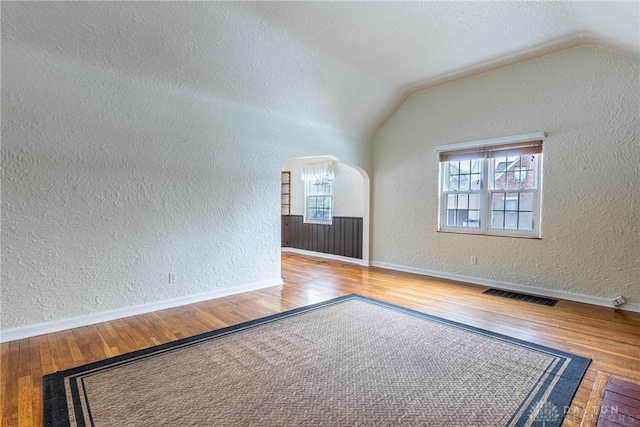 bonus room featuring hardwood / wood-style flooring and vaulted ceiling