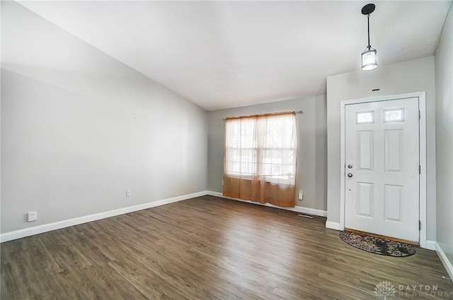 foyer entrance with dark hardwood / wood-style flooring and lofted ceiling