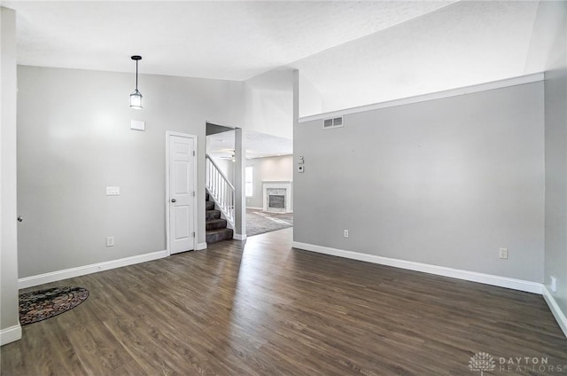 unfurnished living room with dark hardwood / wood-style flooring and high vaulted ceiling