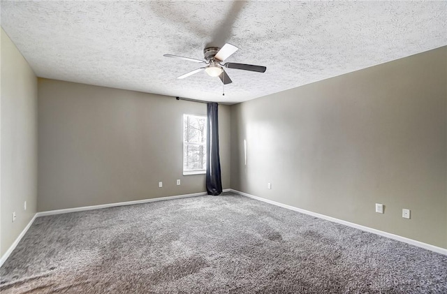 spare room featuring ceiling fan, a textured ceiling, and carpet