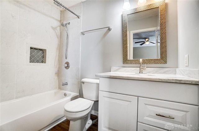 full bathroom featuring vanity, toilet, tiled shower / bath combo, and hardwood / wood-style floors