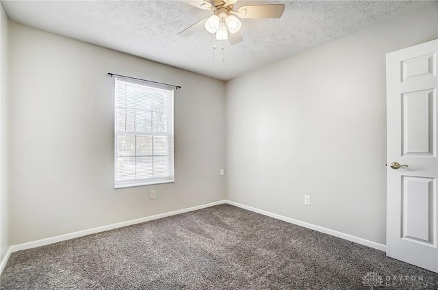 carpeted empty room featuring ceiling fan and a textured ceiling