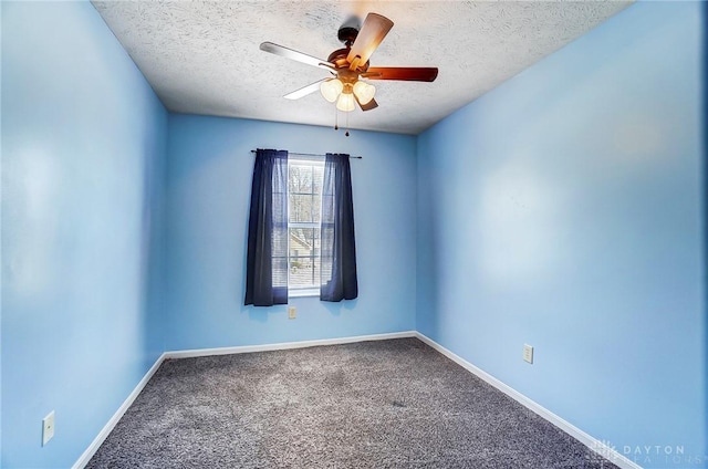 carpeted empty room featuring ceiling fan and a textured ceiling