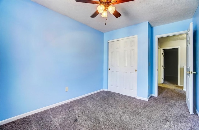 unfurnished bedroom with a textured ceiling, a closet, ceiling fan, and carpet