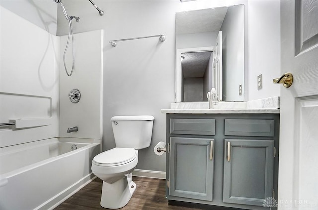 full bathroom featuring shower / washtub combination, wood-type flooring, vanity, and toilet